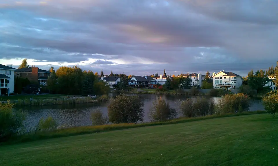 A pond and homes in Sherwood Park at sunset