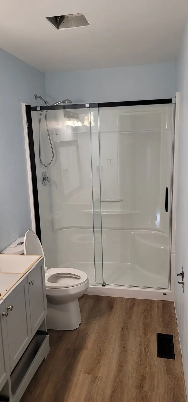 Bathroom with a full-width sliding glass shower: Zenith job-site photo