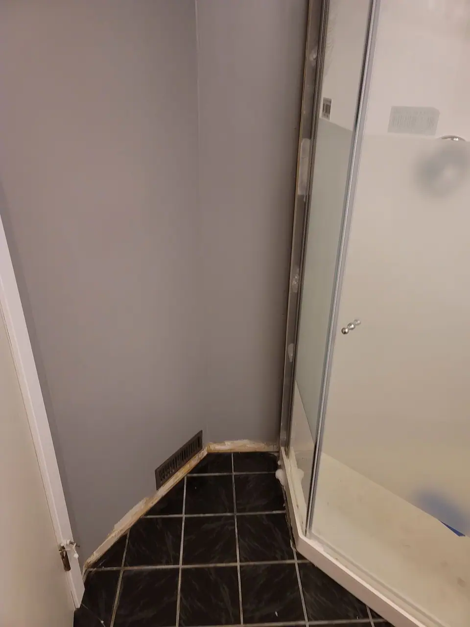 Basement bathroom with a corner glass shower, photo 4 of 9 (finished)
