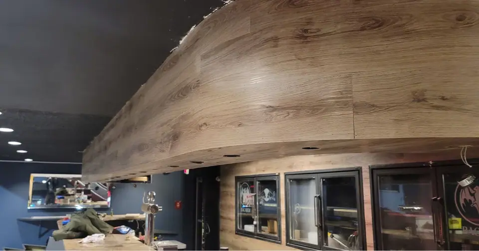 Commercial interior: curved wood-look bulkhead and service wall, photo 14 of 15