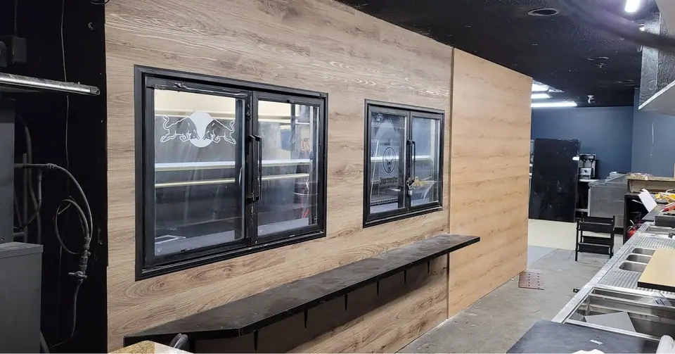 Commercial interior: curved wood-look bulkhead and service wall: Zenith job-site photo