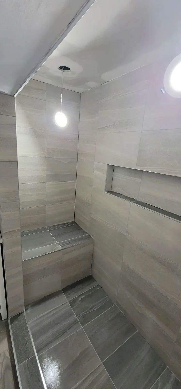 Basement suite bathroom: walk-in shower and stacked laundry, photo 23 of 30 (finished)