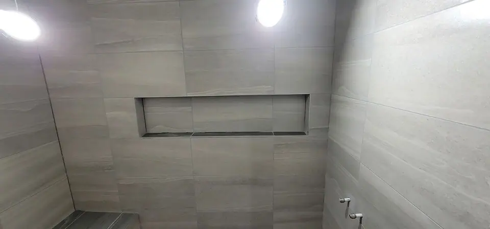 Basement suite bathroom: walk-in shower and stacked laundry, photo 24 of 30 (finished)
