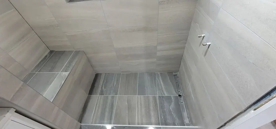 Basement suite bathroom: walk-in shower and stacked laundry, photo 25 of 30 (finished)
