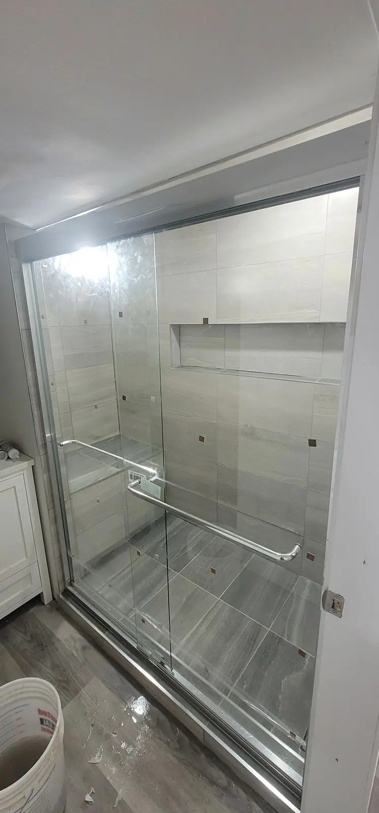 Basement suite bathroom: walk-in shower and stacked laundry, photo 28 of 30 (finished)