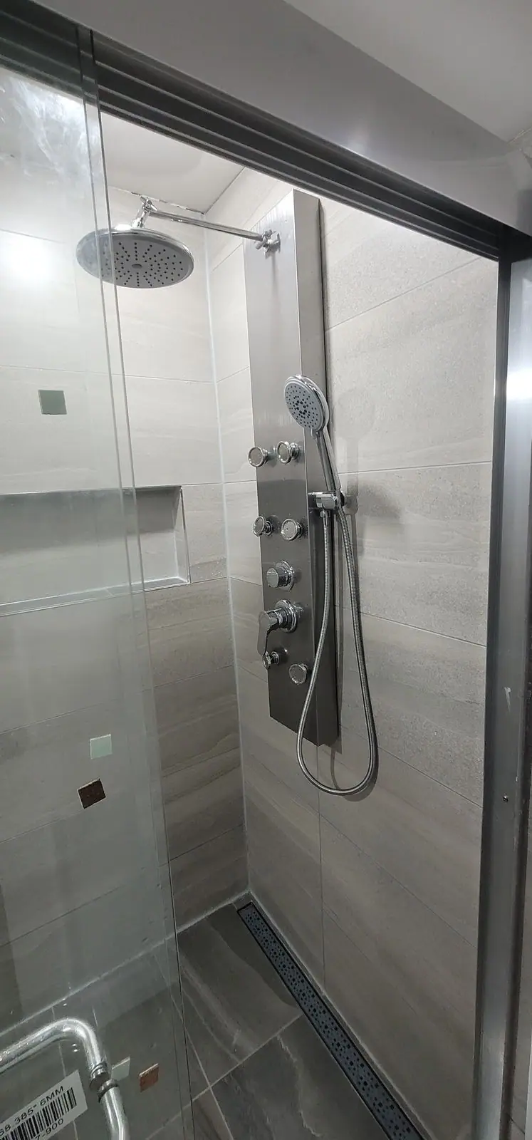 Basement suite bathroom: walk-in shower and stacked laundry, photo 30 of 30 (finished)