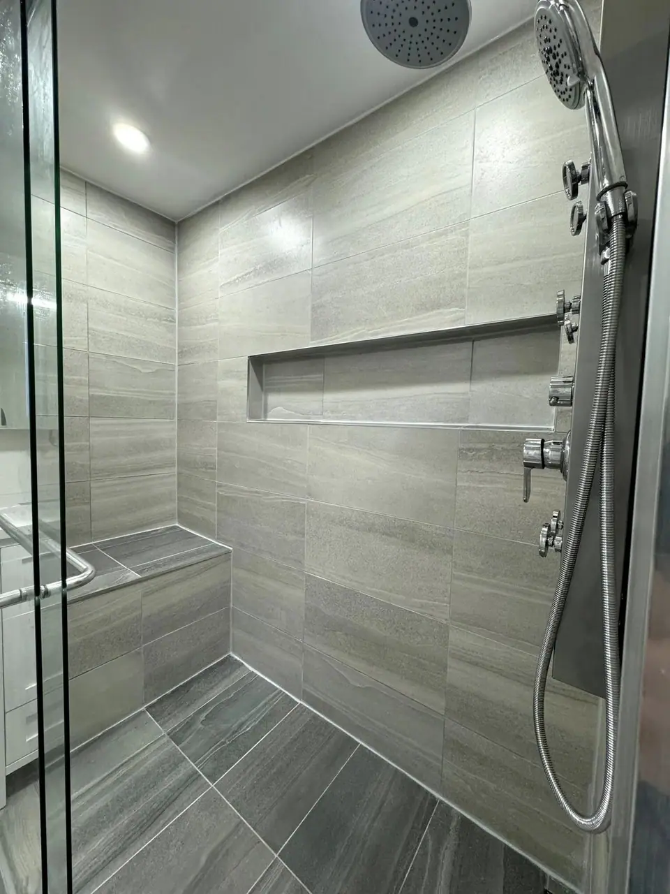 Basement suite bathroom: walk-in shower and stacked laundry: Zenith job-site photo