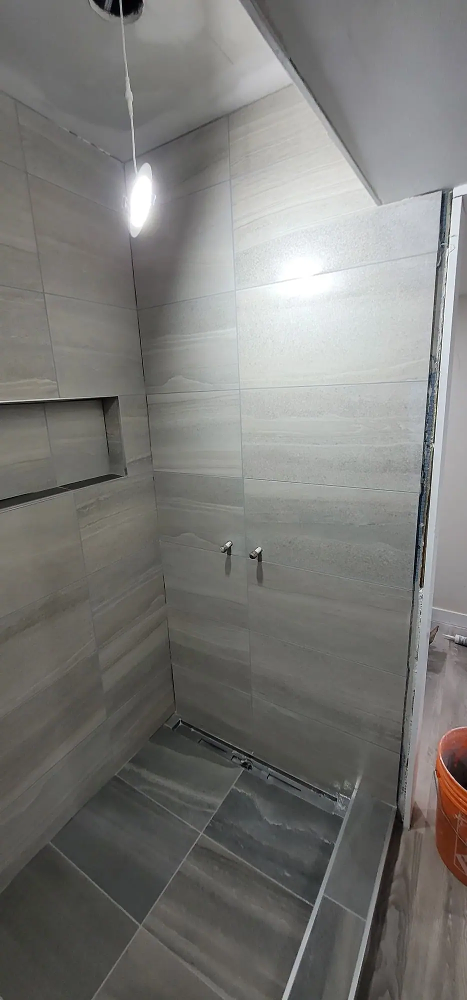 Basement suite bathroom: walk-in shower and stacked laundry, photo 26 of 30 (finished)
