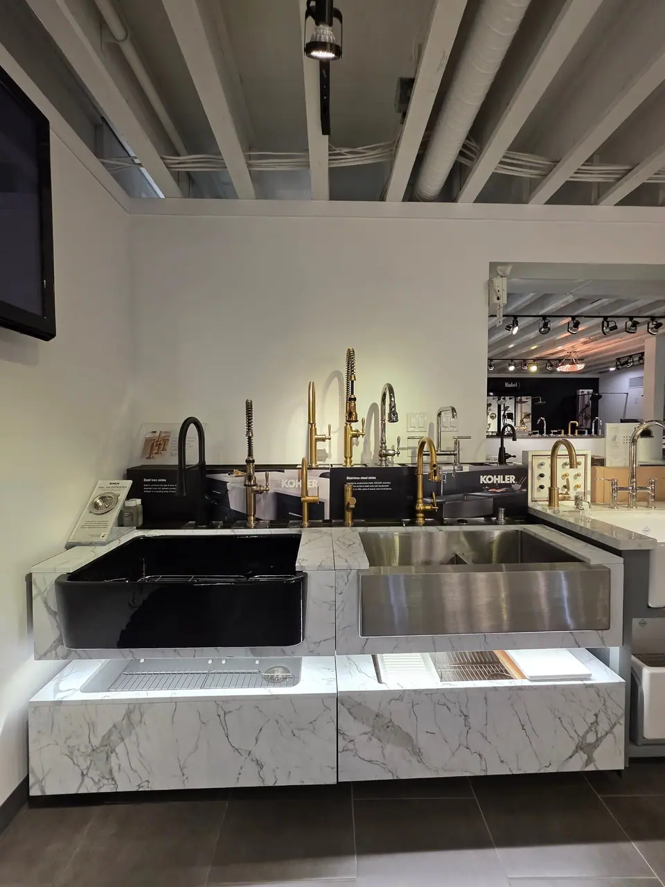 Kitchen sinks and faucets in a KOHLER fixture showroom