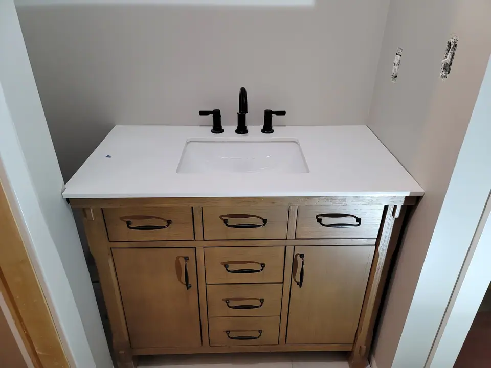 Bathroom rebuild with a skylight well and wood vanity: Zenith job-site photo